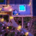 Toit-terrasse avec jacuzzi éclairé et allées du jardin illuminées, l'Hôtel Villa Padulaccia vu du ciel le soir